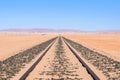 Close up detail view of train tracks leading through the desert near the city of Luderitz in Namibia, Africa. Selective focus on f Royalty Free Stock Photo