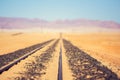 Close up detail view of train tracks leading through the desert near the city of Luderitz in Namibia, Africa. Selective focus on f Royalty Free Stock Photo