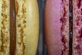 Close up detail of yellow and pink filled macarons