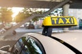 Close-up detail yellow taxi symbol on cars roof stand waiting at parking of airport terminal or railway station against Royalty Free Stock Photo