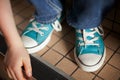 Blue and white high top sneakers with white laces Royalty Free Stock Photo