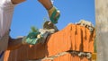 CLOSE UP: Detailed shot of builder's hands as he lays bricks on a sunny day. Royalty Free Stock Photo