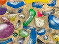 CLOSE UP: Detailed shot of colorful grips covered in chalk at a bouldering gym.