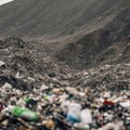 A close-up, detailed view of a landfill, with mountains of garbage extending as far as the eye can see. AI generated