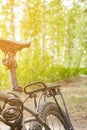 close-up details of a bike against a blurred forest background, front and back background blurred with bokeh effect Royalty Free Stock Photo