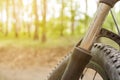 close-up details of a bike against a blurred forest background, front and back background blurred with bokeh effect Royalty Free Stock Photo