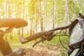 close-up details of a bike against a blurred forest background, front and back background blurred with bokeh effect Royalty Free Stock Photo