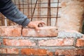 Close up details of worker, bricklayer placing and adjusting bricks. Professional worker building exterior walls Royalty Free Stock Photo