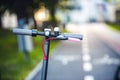 Close up details of electric scooter on the road. Ecological and urban transport in the city. Royalty Free Stock Photo