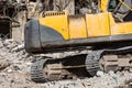 Close up details of excavator tracks on on the ruins of a house Royalty Free Stock Photo