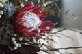 Close-up details of exotic bouquet without packaging stands on table with beige linen tablecloth, environmental floristry concept