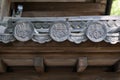 Close up details of Hanagawara or roof tile ornamentation with floral and plant designs in traditional Japanese architecture