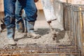 details of house building details - Worker pouring concrete into house beams