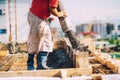 Close-up details of house building details - Worker pouring concrete into house beams