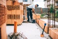 details of industrial bricklayer installing bricks on industrial building, construction site Royalty Free Stock Photo