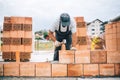 Details of industrial bricklayer installing bricks on construction site Royalty Free Stock Photo