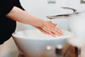 Details of pregnant woman with baby bump washing hands with soap and tap water Royalty Free Stock Photo
