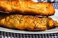 Close up on details of sausages baked in dough sprinkled with salt and poppy seeds. Sausages rolls, delicious homemade pastries