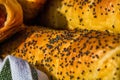 Close up on details of sausages baked in dough sprinkled with salt and poppy seeds. Sausages rolls delicious homemade pastries