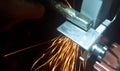 details of sparks, industrial worker using angle grinder and cutting steel