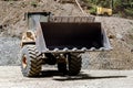 Details of wheel loader with empty scoop and bucket working on construction site Royalty Free Stock Photo