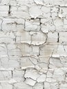 Close-up of a deteriorating white brick wall, showcasing peeling paint that reveals the rough texture beneath. Royalty Free Stock Photo