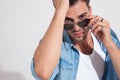 Close up of a determined fashion man adjusting his sunglasses Royalty Free Stock Photo