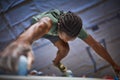 Close Up Of Determined Man Tackling Climbing Wall At Indoor Activity Centre Royalty Free Stock Photo