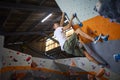 Close Up Of Determined Man Tackling Climbing Wall At Indoor Activity Centre Royalty Free Stock Photo