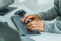 close up developer hand coding with keyboard on desk at modern office