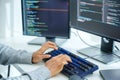 close up developer hand coding with keyboard on desk at modern office