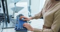 close up developer hand coding with keyboard on desk at modern office