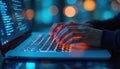 Close-up of developer hands typing code on laptop keyboard in blue neon light at night. Software engineer, data scientist works,