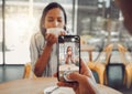 Close up of device screen while taking picture of beautiful young woman drinking coffee and enjoying date in cafe. Man Royalty Free Stock Photo