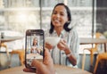 Close up of device screen while taking picture of beautiful young woman holding coffee cup and enjoying date in cafe Royalty Free Stock Photo