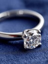 Close-up of a diamond ring on a blue textured background. Royalty Free Stock Photo