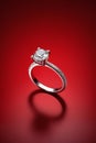 Close up of diamond ring on red background,Generative AI Royalty Free Stock Photo