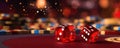 Close-up of dice over a casino table with token chips on the background