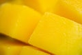 Close up dice yellow mango cut into cubes. Macro shot background. Rip exotic tropial fruit slice Royalty Free Stock Photo