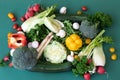 Close-up, different bright vegetables on a green background, flat lay. Royalty Free Stock Photo