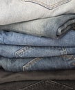 Close up of different colors jeans are stacked in an pile. Royalty Free Stock Photo