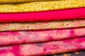 Close up of different fabric of different colors, fabric waiting for sewing clothes and other things, red, yellow fabric Royalty Free Stock Photo