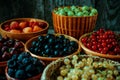 Close up different kind of baskets with fruits on vintage wood background. Red, black and white currant, green and red gooseberry Royalty Free Stock Photo