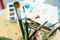 Close up of different painting brushes in paiter`s atelier. Top view. Royalty Free Stock Photo