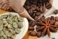 Close-up different types of coffee beans on wooden spoons, green coffee and anise star, macro, set Royalty Free Stock Photo