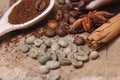 Close-up different types of coffee beans on wooden spoons, green coffee, sticks of cinnamon and anise star, macro, set Royalty Free Stock Photo