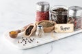 Close up of different types of pepper on a marble slab against a light background. Royalty Free Stock Photo