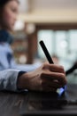 Close up of digital photo editor sitting at desk with multiple displays while using editing software Royalty Free Stock Photo