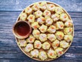 Close up Dim Sum ,Chinese food steamed dumpling and sauce on wooden plate.Top view dumpling on white. Royalty Free Stock Photo