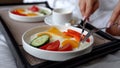 Close-up of a dinner tray with delicious food in the bedroom. Breakfast on the bed in the hotel room. Breakfast at the